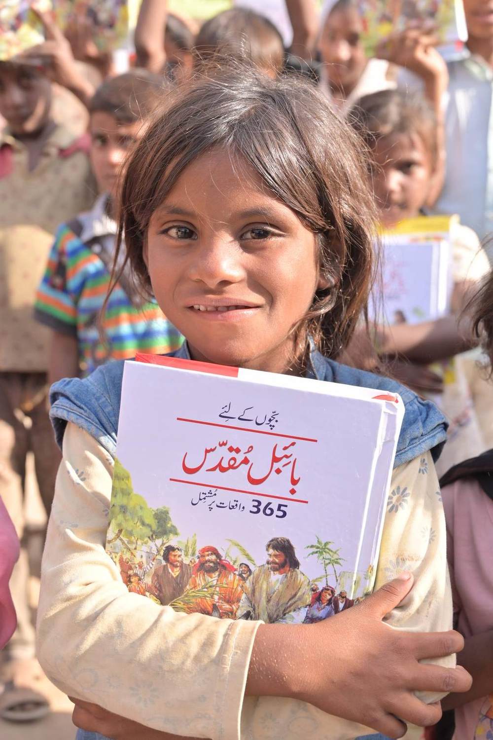 A child with an Urdu Bible